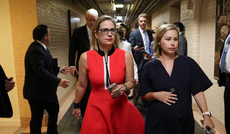 Kyrsten Sinema knows the power of boobs and cleavage…